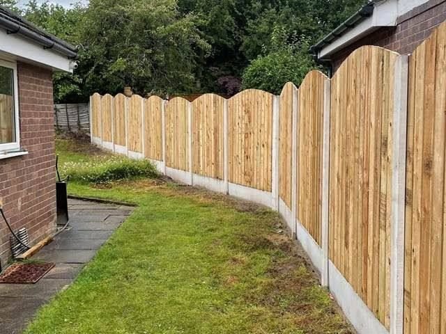 Decorative scalloped-top timber fencing with concrete posts installed by RY Garden & Landscaping